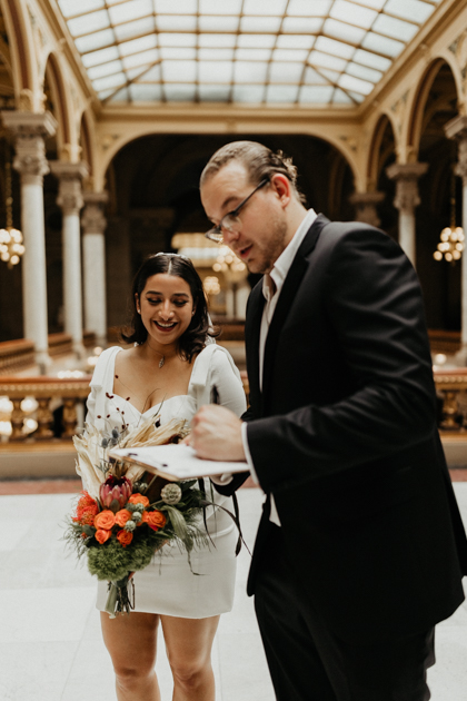 Groom signing marriage certificate