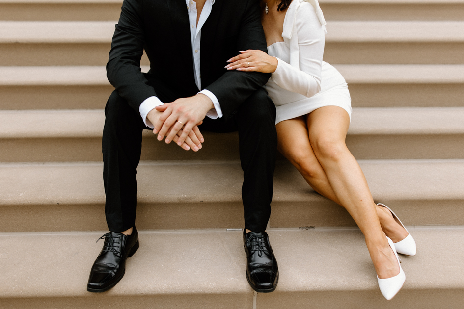 Couple sitting on courthouse steps after elopement 