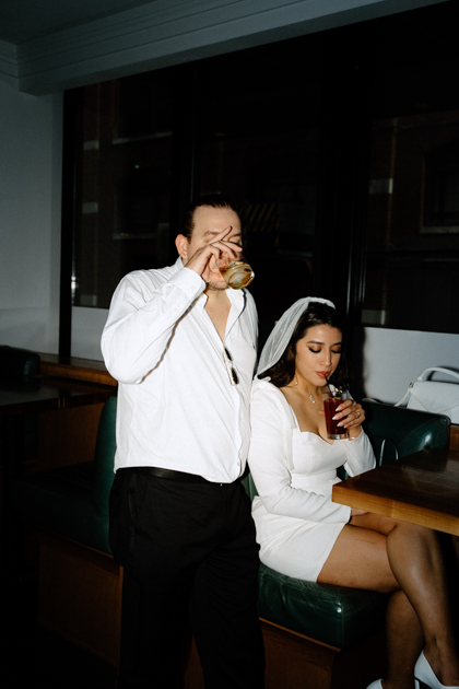 couple having drinks after elopement at spoke and steele bar in indianapolis  