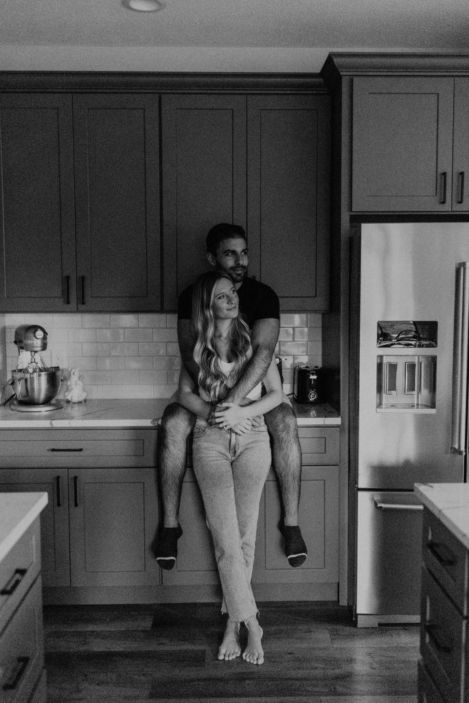 Couple posing in kitchen for in home photoshoot