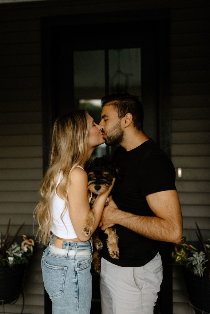 Couple posing with dog during photoshoot