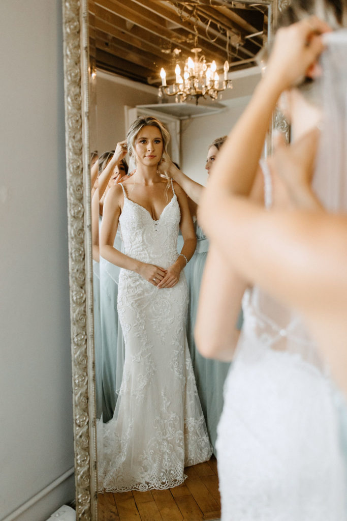 bride getting ready for sage green and white color schemes wedding 