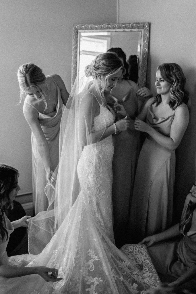 bride getting ready for sage green and white color schemes wedding 