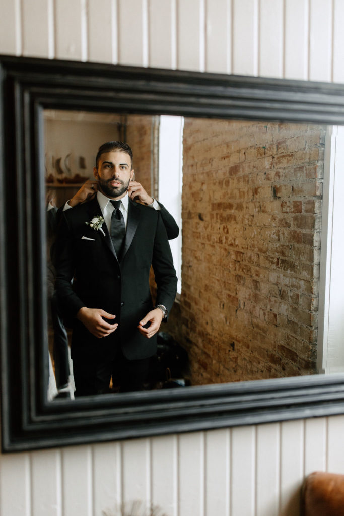 Groom getting ready before Indiana wedding ceremony at Bread and Chocolate wedding venue 