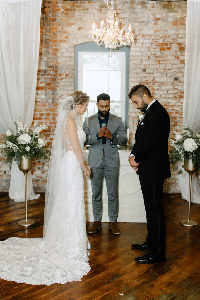 Bride and groom at the atlar at bread and chocolate wedding venue in south bend indiana