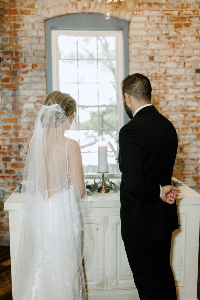 Bride and groom at the atlar at bread and chocolate wedding venue in south bend indiana