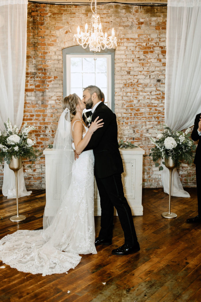 Bride and groom at the atlar at bread and chocolate wedding venue in south bend indiana