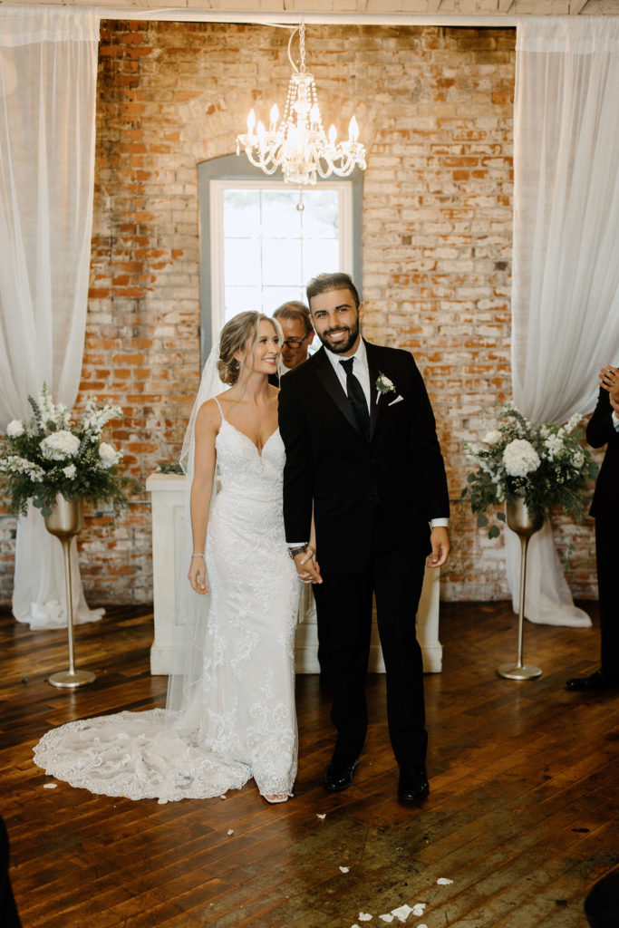 Bride and groom at the atlar at bread and chocolate wedding venue in south bend indiana