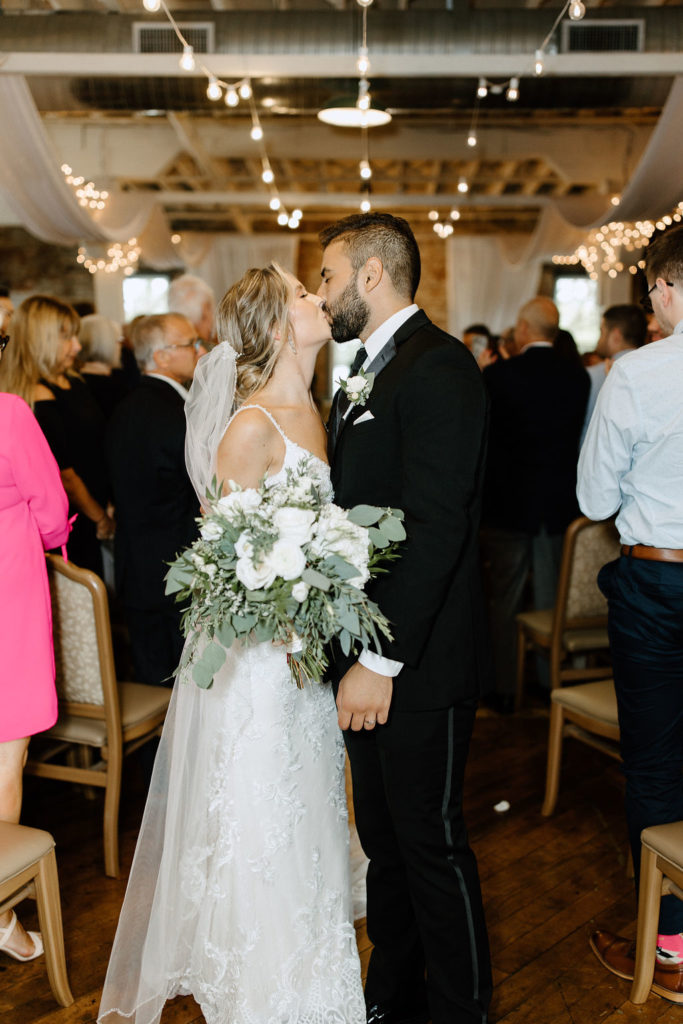 Bride and groom kissing after ceremony