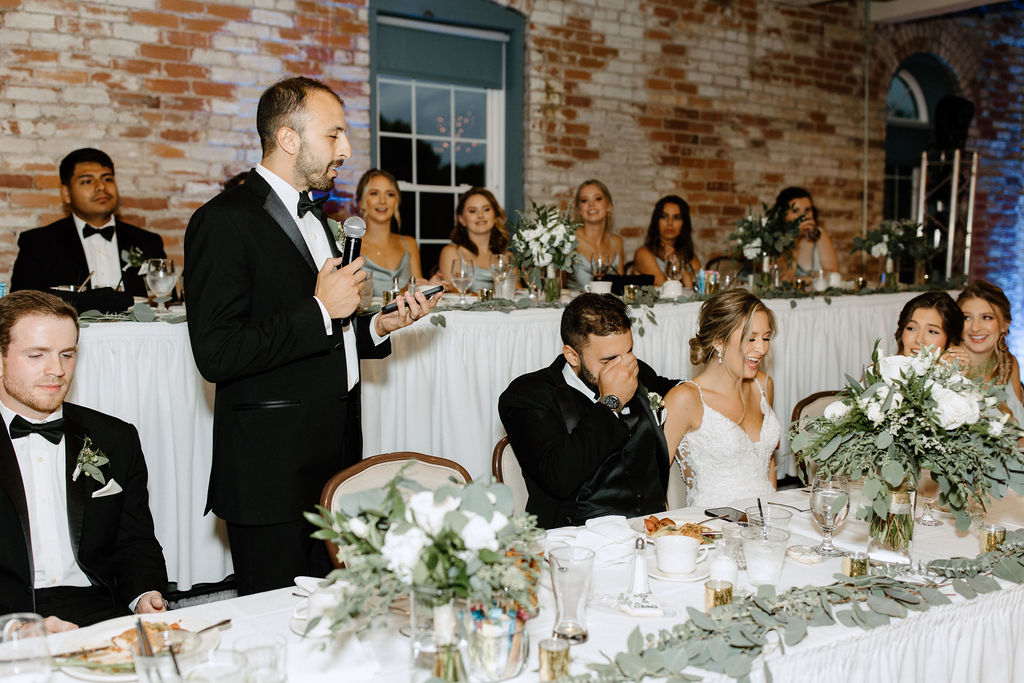 bride and groom during wedding speeches