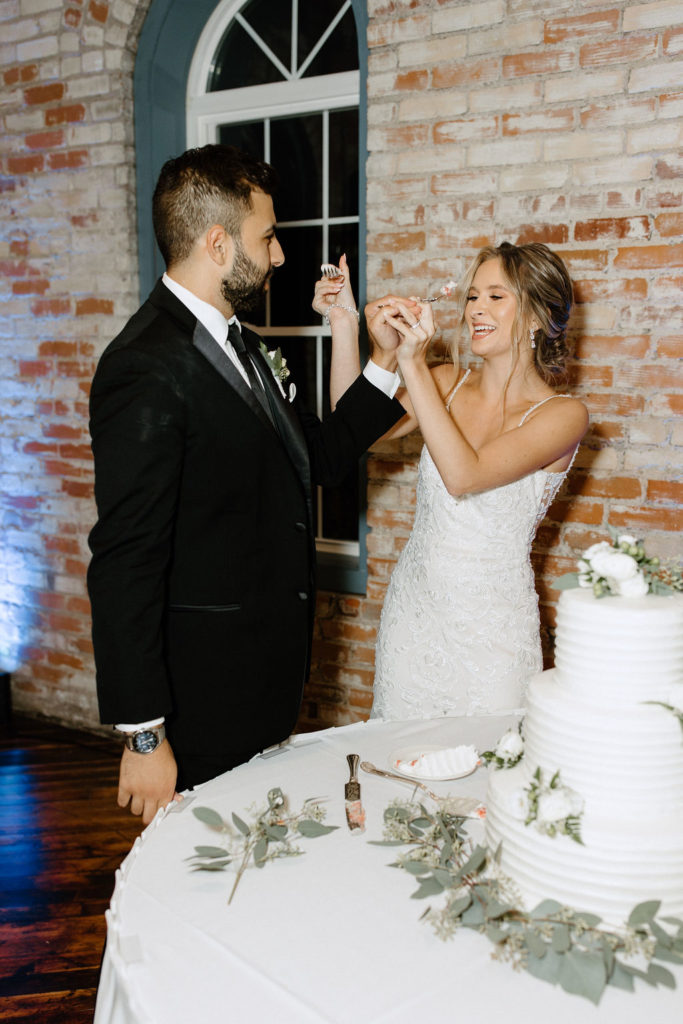 bride and groom cutting wedding cake