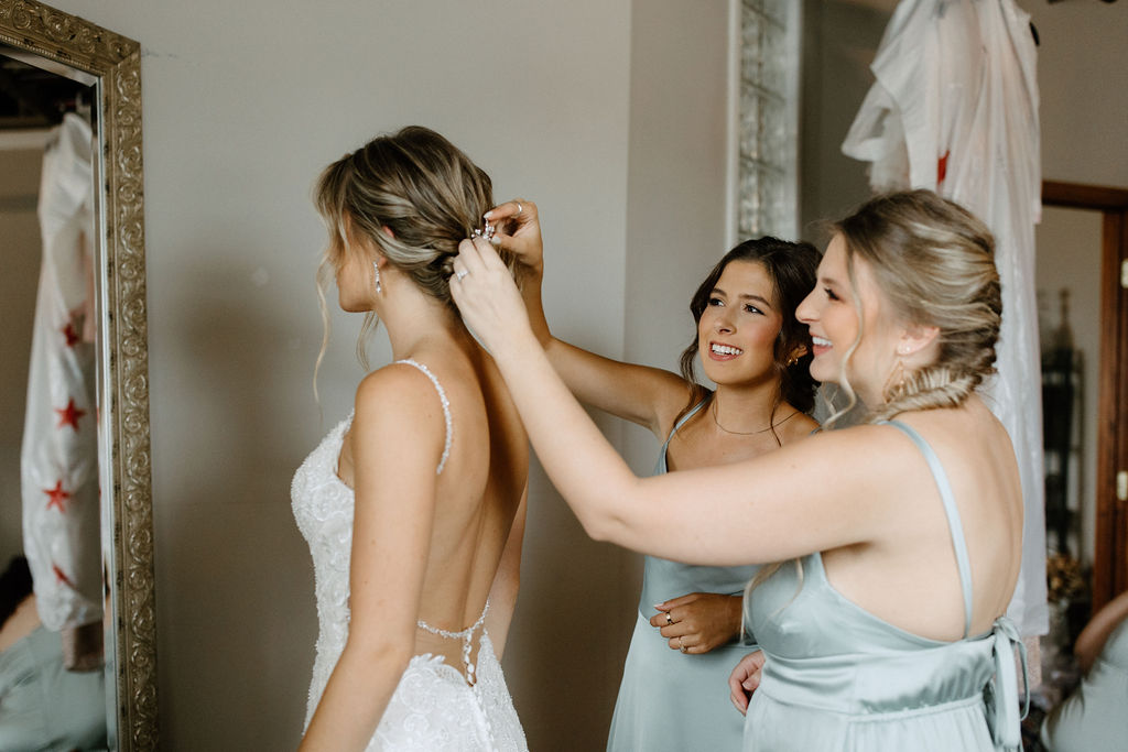 bride getting ready for sage green and white color schemes wedding 