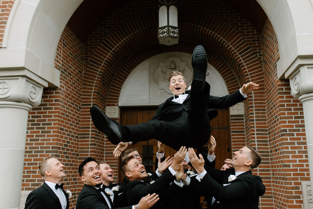 groomsmen throwing groom in the air before ceremony exit wedding ideas