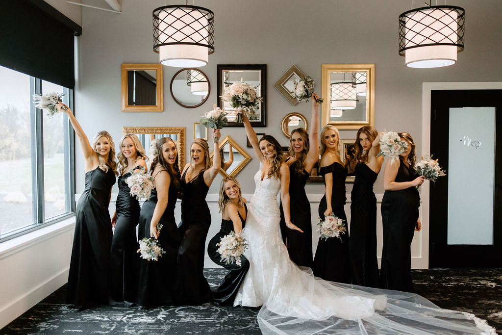 bride and bridesmaids posing for photos before wedding