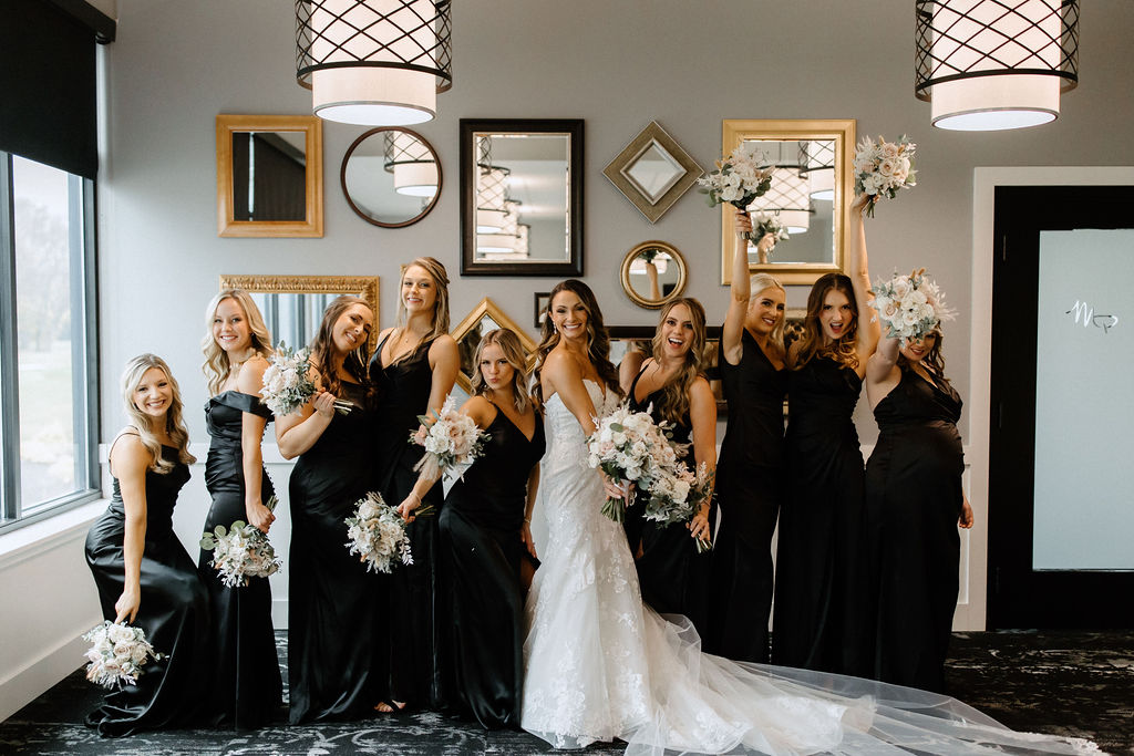 bride and bridesmaids posing for photos before wedding