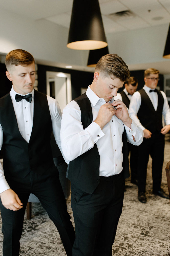 groom and groomsmen getting ready before wedding