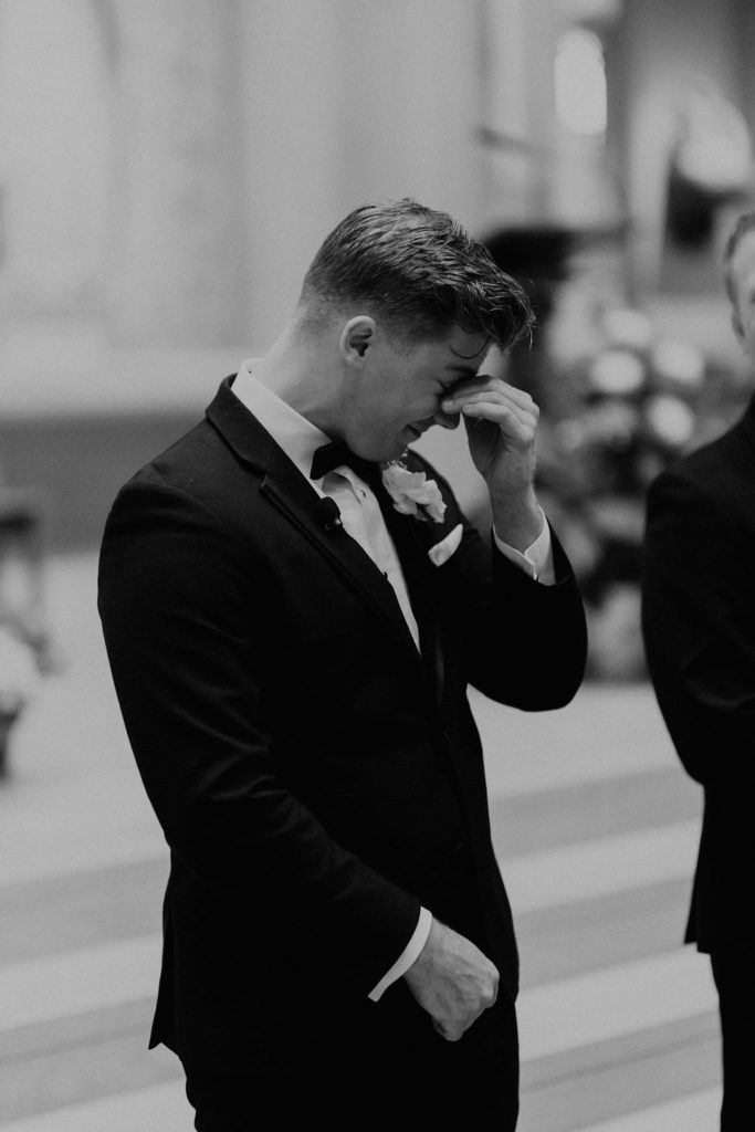 groom emotional after seeing his bride walking down the aisle