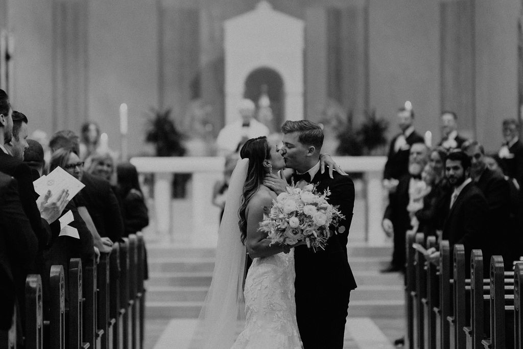 bride and groom kissing after ceremony