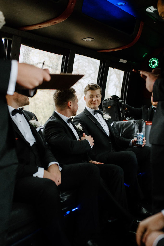 groom and groomsmen on the bus before ceremony