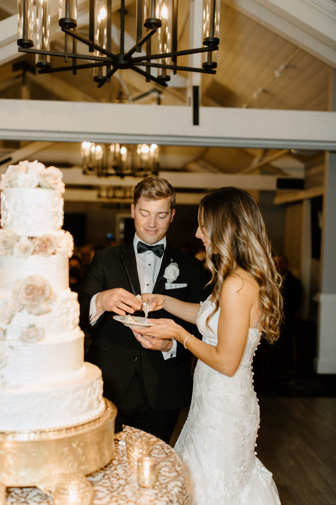 bride and groom cutting wedding cake