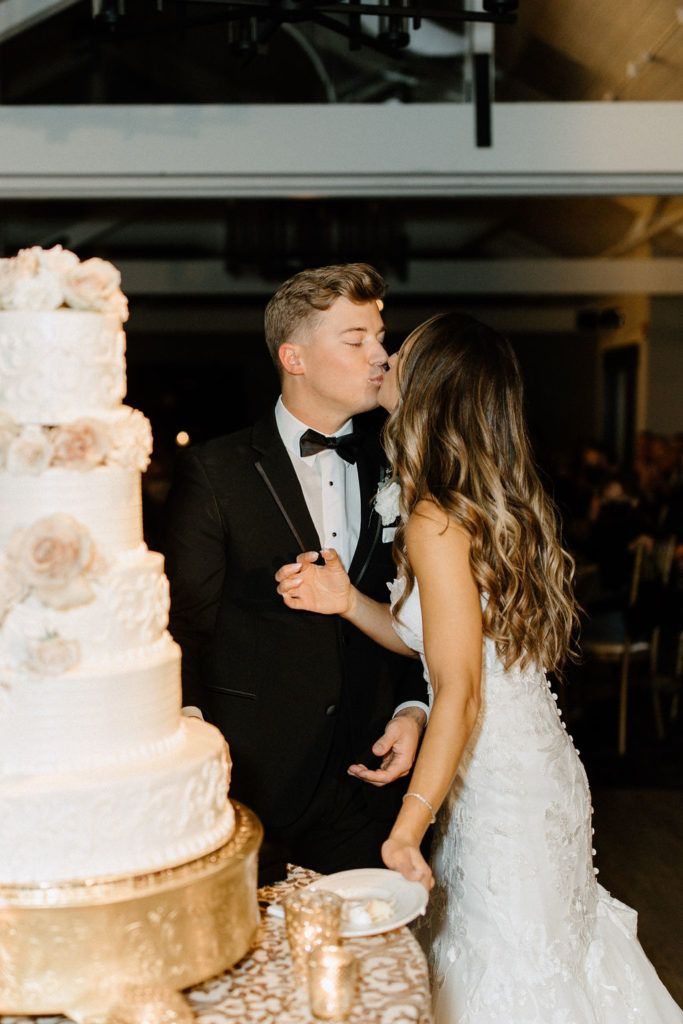 bride and groom cutting wedding cake