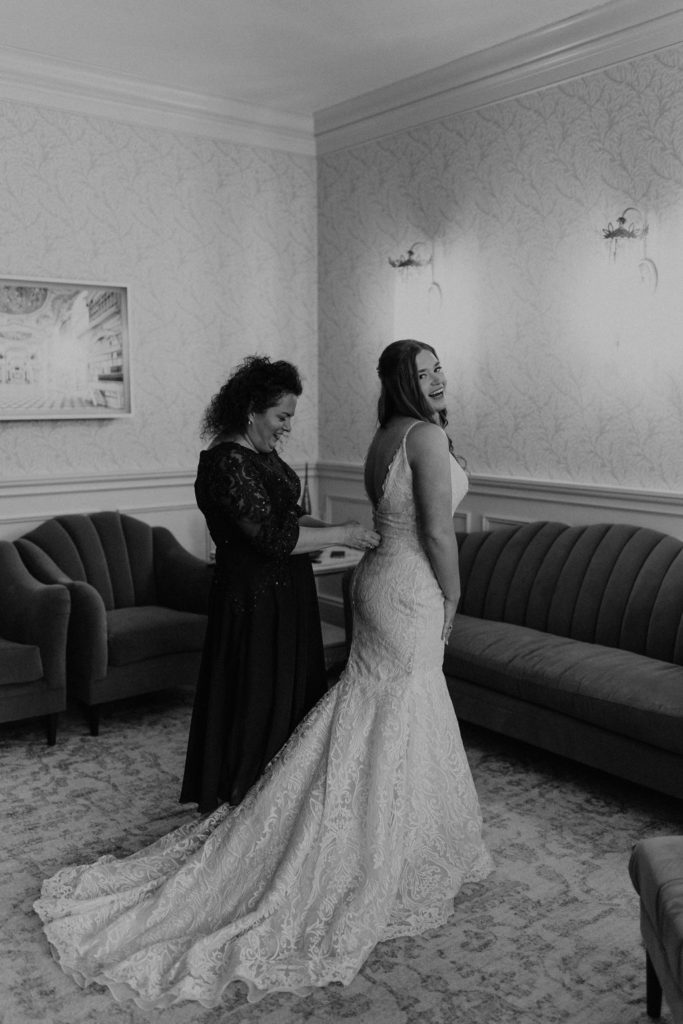 Bride getting dressed before wedding ceremony