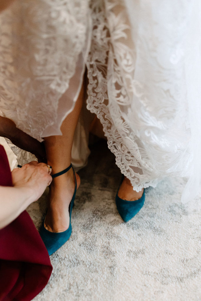 Bride getting dressed before wedding ceremony