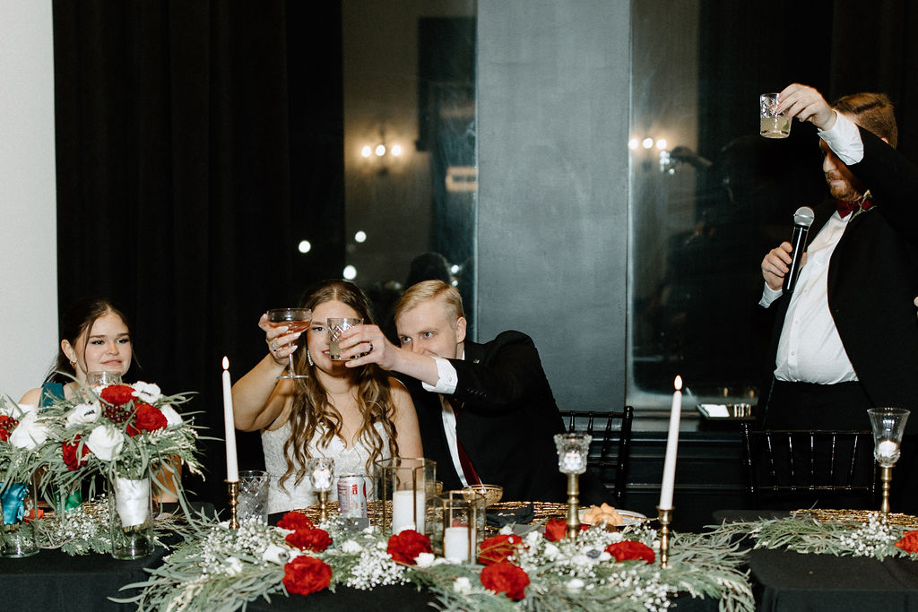 Bride and groom toasting at reception