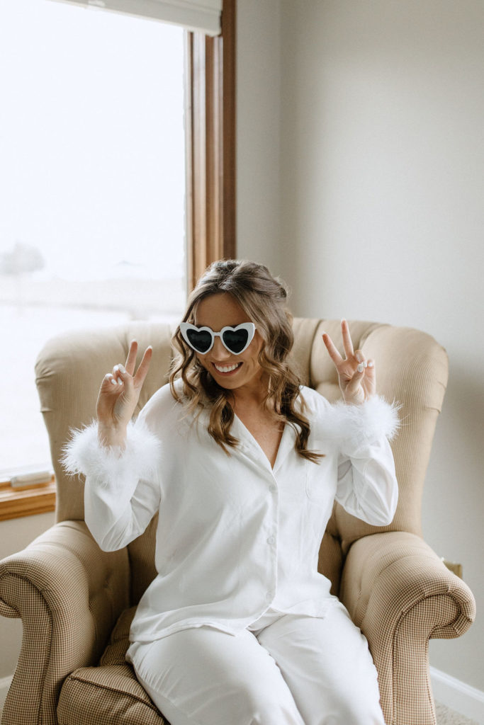 Bride wearing sunglasses and fur pajamas