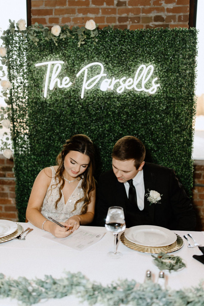 Bride and groom signing marriage certificate