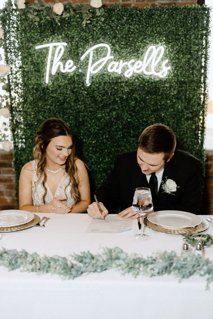 Bride and groom signing marriage certificate