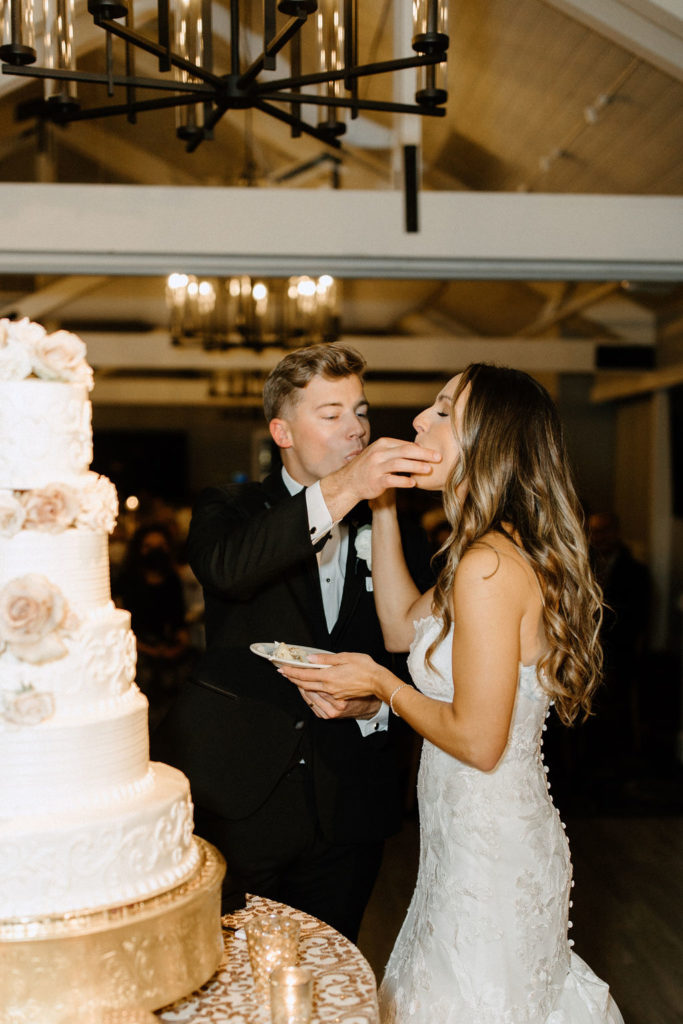 bride and groom cutting wedding cake