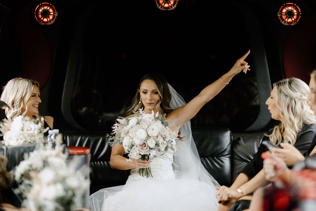 Bride and bridemaids on bus before wedding at The Morris Park Country club wedding venue in South Bend, IN