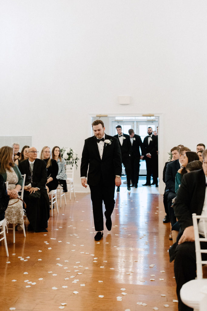 Groom walking down the aisle