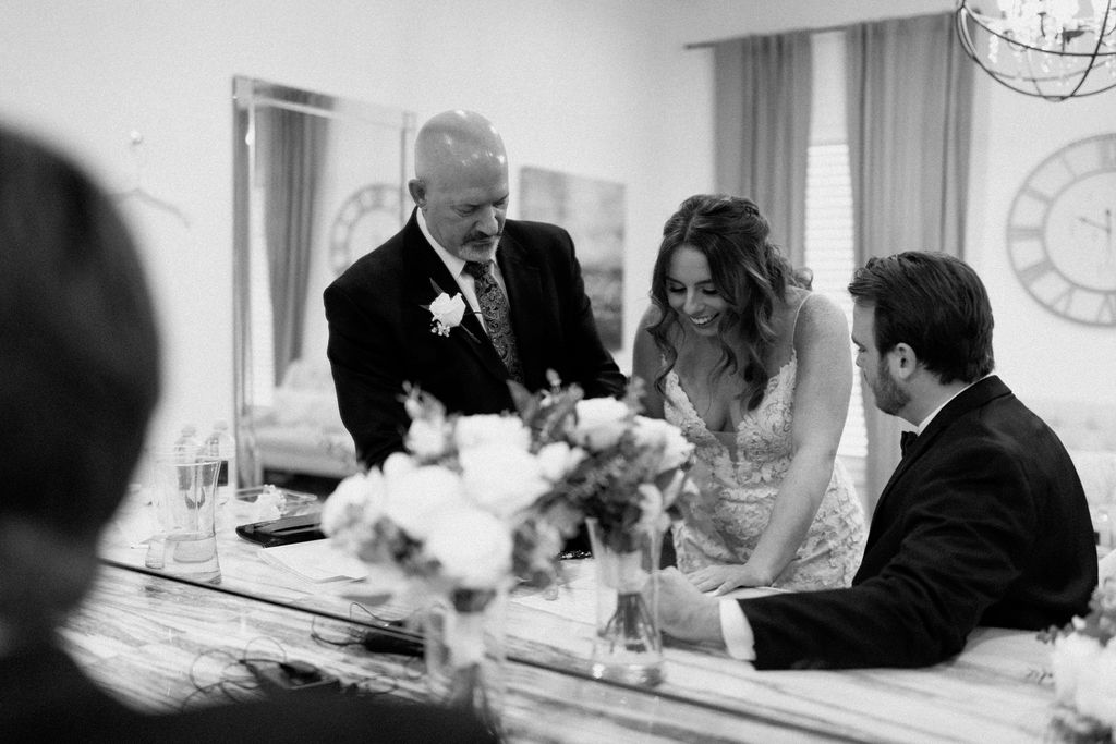 Bride and groom signing marriage license