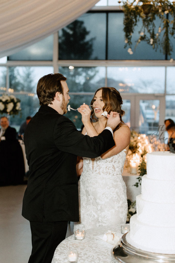 Bride and groom cutting wedding cake